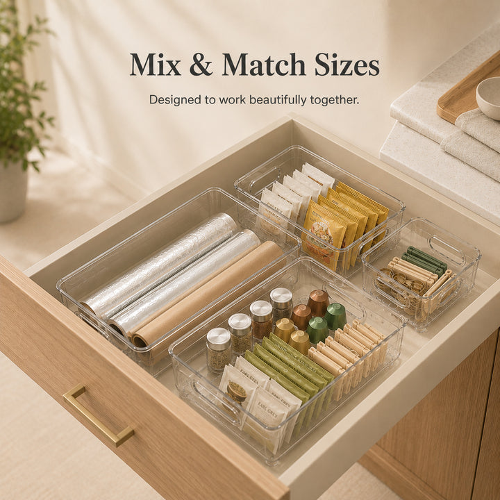 Clear Drawer Organizer in multiple sizes working together to organise a modern kitchen drawer.