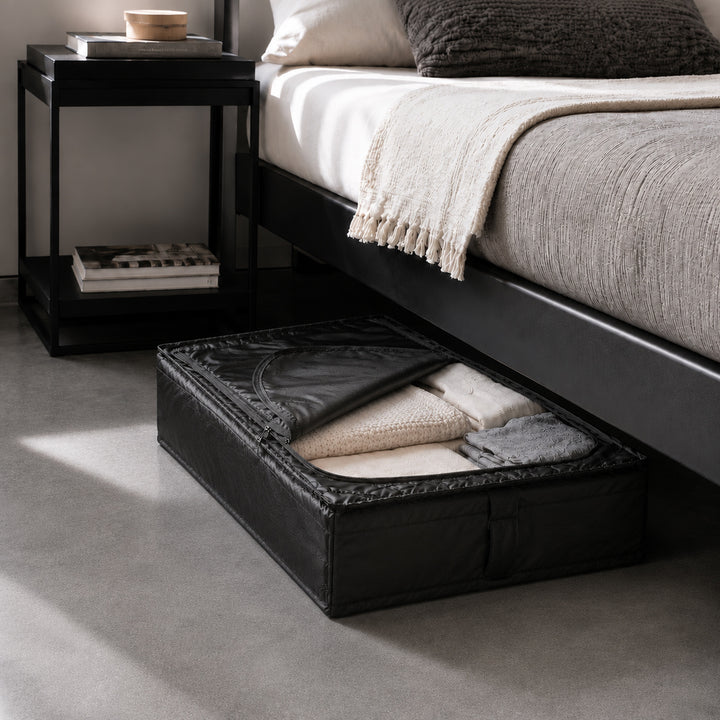 Foldable under-bed storage organizer partially pulled out with folded bedding and seasonal clothes